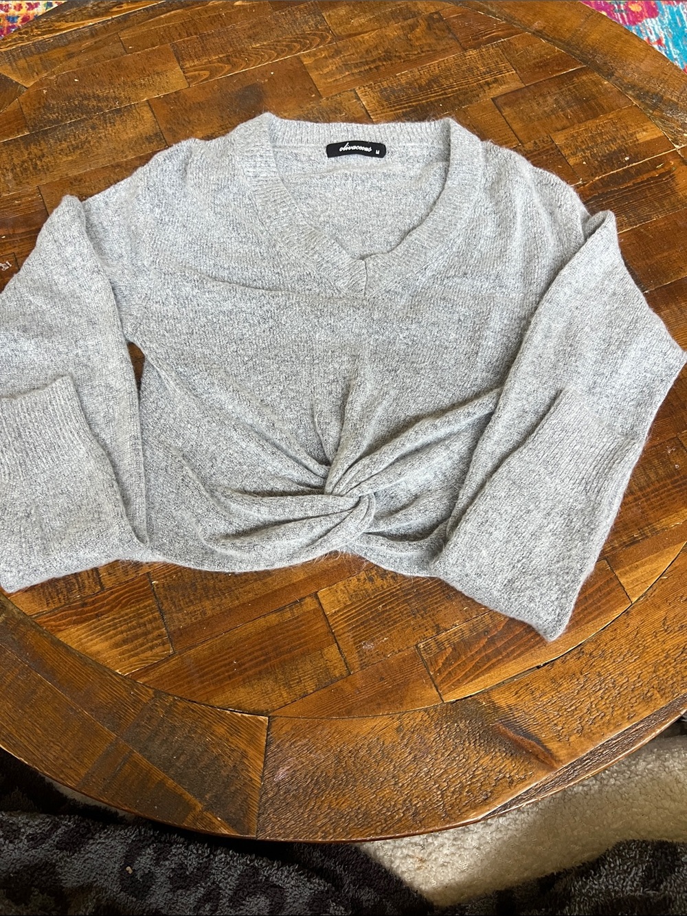 Grey soft sweater with knot design on front